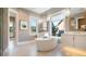 A luxurious bathroom featuring a standalone tub, dual vanities, and shiplap walls at 4 Preserve Rd, Johns Island, SC 29455