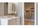 A clean bathroom features a white vanity, shiplap walls, and an open doorway to a closet at 4 Preserve Rd, Johns Island, SC 29455