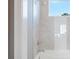 Bright white bathroom with shower and tub combination, with a tile surround and window at 4 Preserve Rd, Johns Island, SC 29455