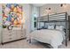 A bedroom features a bunk bed, large colorful artwork, and lots of natural light at 4 Preserve Rd, Johns Island, SC 29455