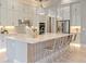 Modern white kitchen with a large island, stainless steel appliances, and bright lighting at 4 Preserve Rd, Johns Island, SC 29455