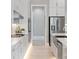 Well-lit kitchen featuring modern appliances, white cabinets, and a stainless steel sink at 4 Preserve Rd, Johns Island, SC 29455