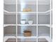 Pantry shelving featuring a woven basket on a lower shelf and dry-goods in matching jars at 4 Preserve Rd, Johns Island, SC 29455