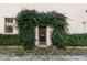 Charming home entrance showcases a black door framed by lush greenery and stone pathway to create an inviting allure at 40 State St # 1, Charleston, SC 29401