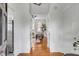 Bright hallway features hardwood floors, white trim and offers a glimpse of a cozy living room with a large window at 40 State St # 1, Charleston, SC 29401
