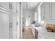 Galley kitchen featuring white cabinetry, stainless steel appliances, and marble countertops at 40 State St # 1, Charleston, SC 29401