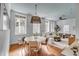 Open-concept area with stylish living and dining, featuring hardwood floors, modern furnishings and ample natural light at 40 State St # 1, Charleston, SC 29401