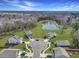 Aerial view of a residential area with houses surrounding a cul-de-sac and a scenic pond at 409 Spruce Ivy St, Moncks Corner, SC 29461