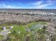 Expansive aerial view of a neighborhood with a large pond and wooded areas at 409 Spruce Ivy St, Moncks Corner, SC 29461