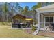 Beautiful backyard featuring an outdoor kitchen, screened porch, and lush landscaping for outdoor entertaining at 409 Spruce Ivy St, Moncks Corner, SC 29461