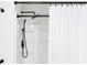 Close-up of a sleek, modern shower with black fixtures and a white shower curtain at 409 Spruce Ivy St, Moncks Corner, SC 29461