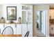 Open dining area with custom built-in cabinets, glass shelves, and a view to other rooms at 409 Spruce Ivy St, Moncks Corner, SC 29461
