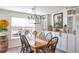 Bright dining room featuring a wood table, chandelier, and views of the backyard at 409 Spruce Ivy St, Moncks Corner, SC 29461
