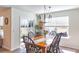 Bright dining room featuring a wood table, views of the backyard, and modern light fixtures at 409 Spruce Ivy St, Moncks Corner, SC 29461
