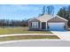 Charming single-story home featuring a well-manicured lawn and attached two-car garage at 409 Spruce Ivy St, Moncks Corner, SC 29461