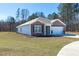 Well-maintained single-story home with attached two-car garage and green front lawn at 409 Spruce Ivy St, Moncks Corner, SC 29461