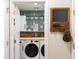 Neat laundry room with modern appliances and decorative wallpaper creating a functional yet stylish space at 409 Spruce Ivy St, Moncks Corner, SC 29461