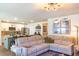 Comfortable living room featuring an L-shaped sofa, adjacent to an eat-in kitchen at 409 Spruce Ivy St, Moncks Corner, SC 29461