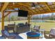 Outdoor kitchen with a covered pavilion, a built-in grill, a fire pit, and comfortable seating at 409 Spruce Ivy St, Moncks Corner, SC 29461