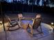 Outdoor patio with rocking chairs, a fire pit, and accent lighting, perfect for evening gatherings at 409 Spruce Ivy St, Moncks Corner, SC 29461