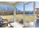 Relaxing screened porch with comfortable seating and a scenic view of the backyard and pond at 409 Spruce Ivy St, Moncks Corner, SC 29461