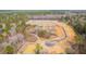 Community under construction aerial view reveals the layout, roads, and pond of the developing neighborhood at 4139 Rising Tide Dr, Summerville, SC 29485