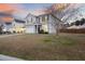 Charming two-story home with gray siding and a spacious front yard, offering a welcoming and picturesque setting at 416 Forest Hills Rd, Summerville, SC 29486