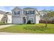 Attractive two-story home with gray siding and an attached garage, surrounded by a green lawn at 416 Forest Hills Rd, Summerville, SC 29486