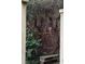 Lush backyard oasis featuring a beautiful brick wall, roses, and a peaceful stone bench at 42 1/2 Hasell St, Charleston, SC 29401