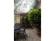 Charming backyard patio featuring lovely greenery, brick wall and elegant metal table set at 42 1/2 Hasell St, Charleston, SC 29401