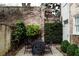 Inviting backyard features a dining set, lush greenery and a partial view of the building at 42 1/2 Hasell St, Charleston, SC 29401