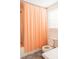 Bathroom featuring a shower with an orange curtain and a toilet at 42 1/2 Hasell St, Charleston, SC 29401