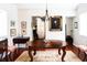 Bright dining room with hardwood floors, an elegant chandelier, and classic furnishings at 42 1/2 Hasell St, Charleston, SC 29401