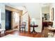 Inviting entryway showcasing a brick accent wall, hardwood floors, and staircase at 42 1/2 Hasell St, Charleston, SC 29401