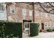 Exterior brick home features a courtyard and lush green landscaping at 42 1/2 Hasell St, Charleston, SC 29401
