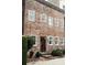 Exterior brick home features a weathered door and lush landscaping at 42 1/2 Hasell St, Charleston, SC 29401