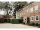 Charming brick home with a lush green landscape and gravel driveway at 42 1/2 Hasell St, Charleston, SC 29401