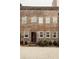 Two story brick home with a weathered door and lush landscaping at 42 1/2 Hasell St, Charleston, SC 29401