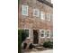 A classic brick home with white-trimmed windows, set amidst greenery at 42 1/2 Hasell St, Charleston, SC 29401