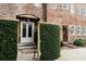 Exterior brick home features a courtyard and lush green landscaping at 42 1/2 Hasell St, Charleston, SC 29401
