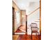 Bright foyer features a wooden staircase, exposed brick, and rich hardwood floors at 42 1/2 Hasell St, Charleston, SC 29401