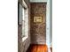Hallway with exposed brick and a painting on the wall at 42 1/2 Hasell St, Charleston, SC 29401