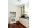 Bright kitchen featuring white cabinetry, appliances, and dark wood floors at 42 1/2 Hasell St, Charleston, SC 29401