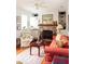 Charming living room with brick fireplace, built-in shelving, and a ceiling fan at 42 1/2 Hasell St, Charleston, SC 29401