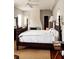 Spacious bedroom with dark wood furniture, including a four-poster bed and dresser at 42 1/2 Hasell St, Charleston, SC 29401
