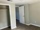 Bedroom featuring gray laminate flooring, neutral walls, and a closet with a wooden rod at 4230 S Rhett Ave, North Charleston, SC 29405