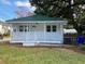 Charming single-story home with a green metal roof and a lovely white porch at 4230 S Rhett Ave, North Charleston, SC 29405