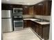 Well-equipped kitchen with stainless steel appliances, dark cabinetry, and a stylish sink at 4230 S Rhett Ave, North Charleston, SC 29405