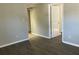 A bright living room with laminate flooring and neutral walls, leading to other rooms at 4230 S Rhett Ave, North Charleston, SC 29405