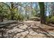 View of large partially fenced backyard with mature trees, metal carport and grass at 425 Ravenwood Rd, Walterboro, SC 29488